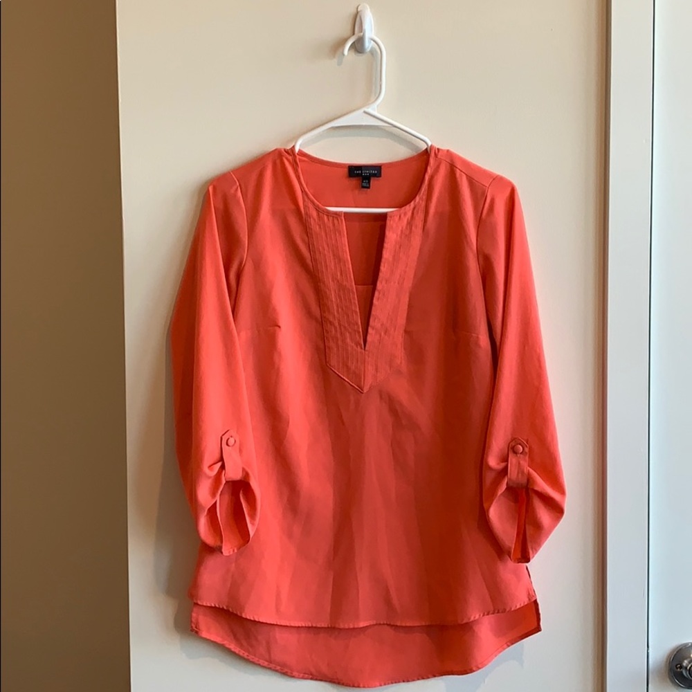 Slightly high, low, salmon colored blouse